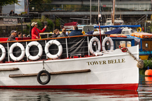 Large tour boat Tower Belle in Bristol harbour, with socially-distanced groups of tourists on board