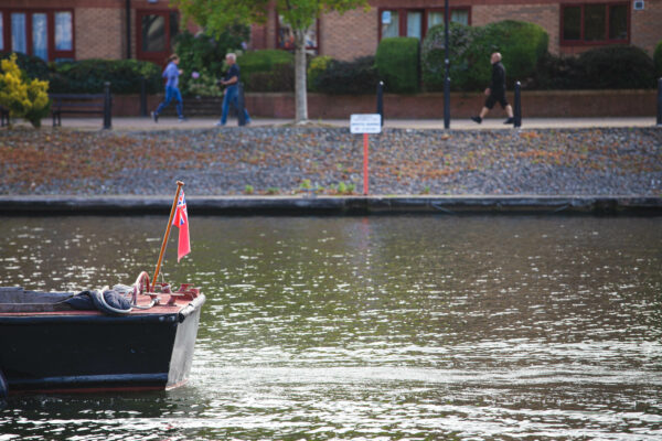 The stern of a boat passing out of the frame, Bristol harbour