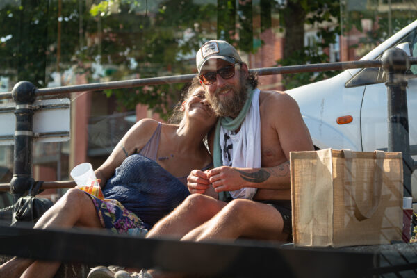 A happy couple sit on the edge of the harbourside during Bristol's harbour festival.