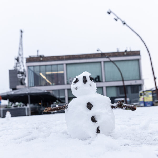 A tiny snowman standing in front of the M-Shed, Bristol