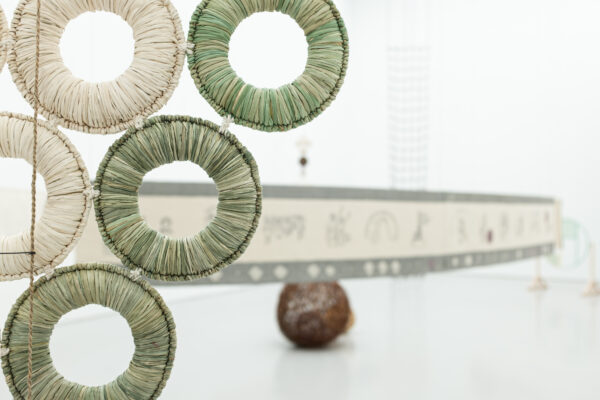 Fabric linked circles sculpture at the Spike Island gallery with a tapestry in the background.